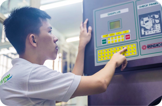 A Dobi Akasia specialist operating professional garment-care equipment